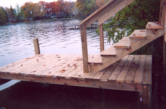 Permanent staircase and beach landing deck connecting to dock